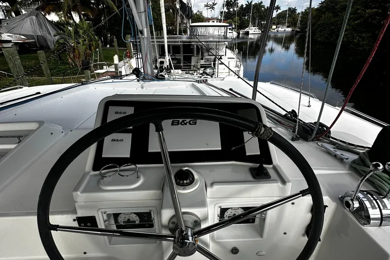 Slide: The Image of Cockpit view of 2017 Lagoon 450 F catamaran with steering wheel and navigation equipment. - 49