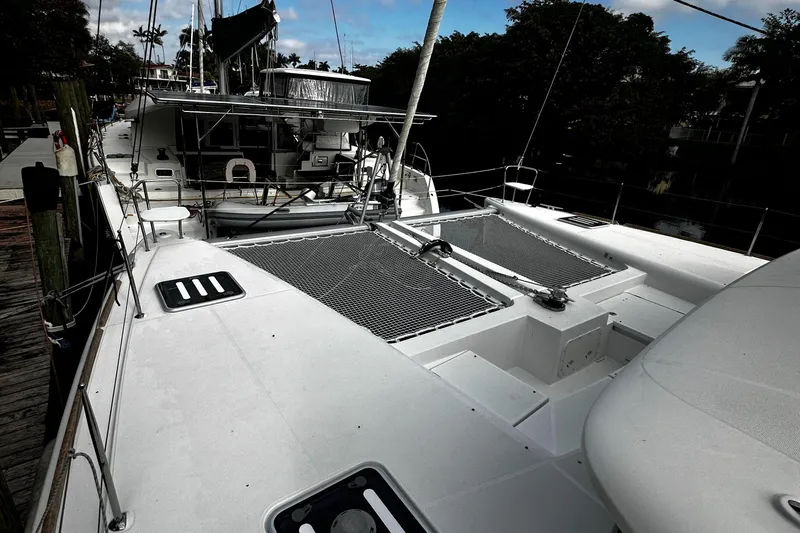 Slide: The Image of 2017 Lagoon 450 F catamaran docked, showcasing spacious deck and sleek design. - 5