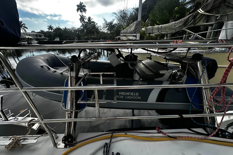 Slide: The Image of 2017 Lagoon 450 F yacht with Highfield tender, docked in a tropical setting. - 71