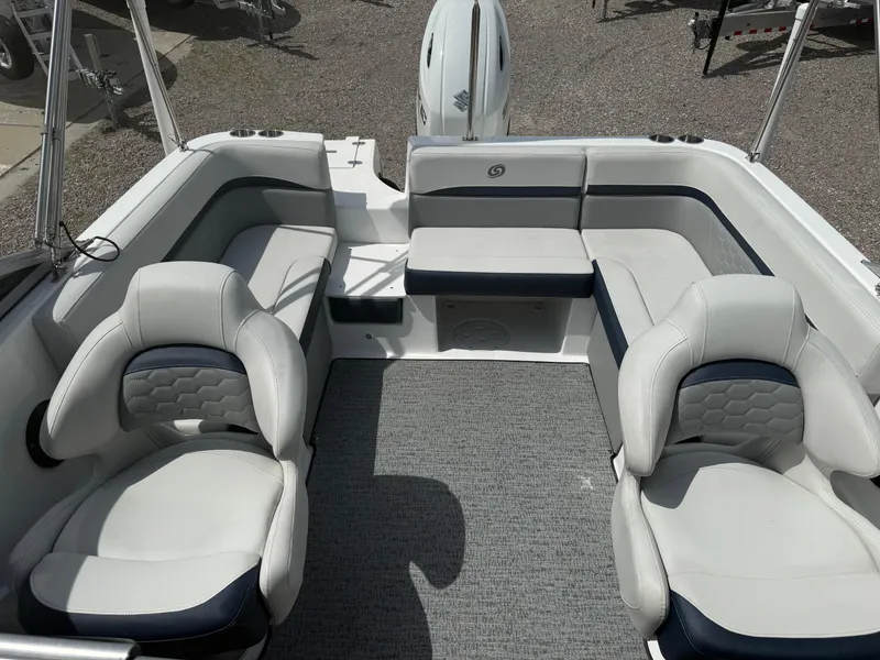 Slide: The Image of 2021 Hurricane SunDeck 217 OB boat interior with white and gray seating arrangement. - 13
