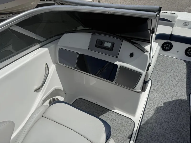 Slide: The Image of 2021 Hurricane SunDeck 217 OB boat interior with modern dashboard and seating. - 15