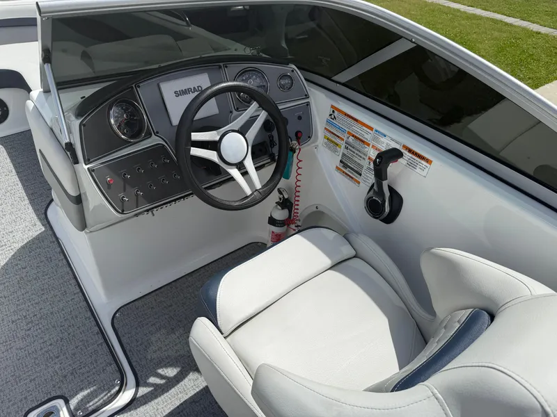 Slide: The Image of 2021 Hurricane SunDeck 217 OB boat cockpit with steering wheel and control panel. - 16