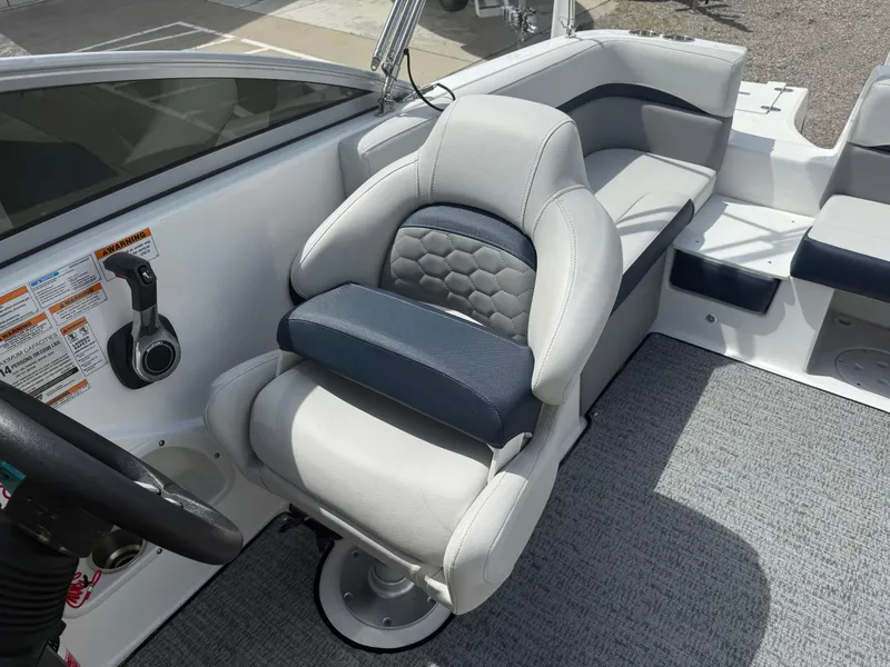 Slide: The Image of Captain's seat on 2021 Hurricane SunDeck 217 OB boat, featuring modern design and comfortable upholstery. - 18