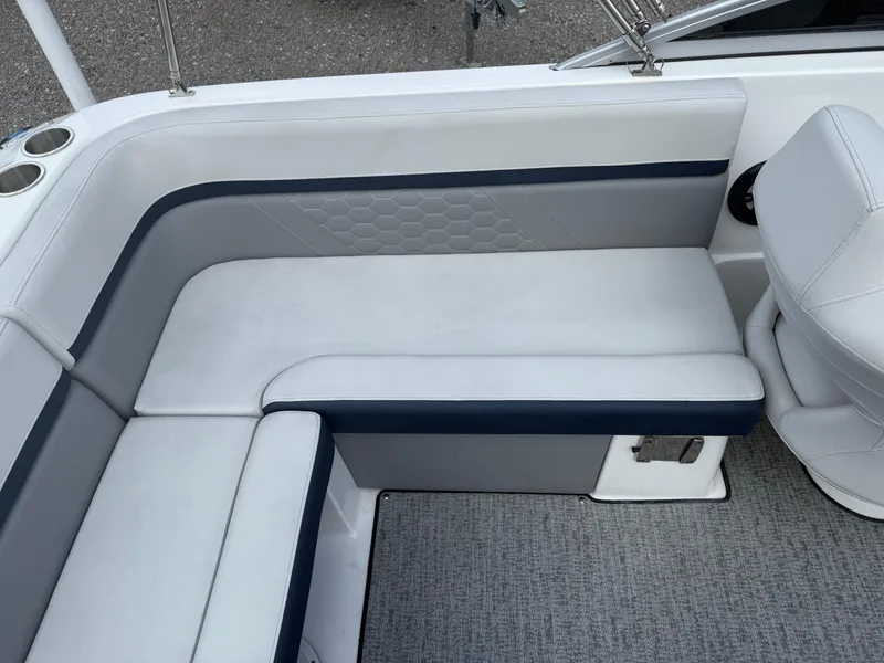Slide: The Image of 2021 Hurricane SunDeck 217 OB boat interior with white and navy seating, textured design. - 20