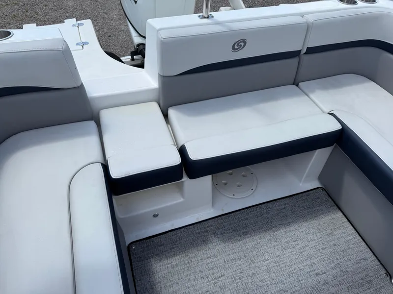 Slide: The Image of 2021 Hurricane SunDeck 217 OB boat seating area with cushioned seats and gray flooring. - 24