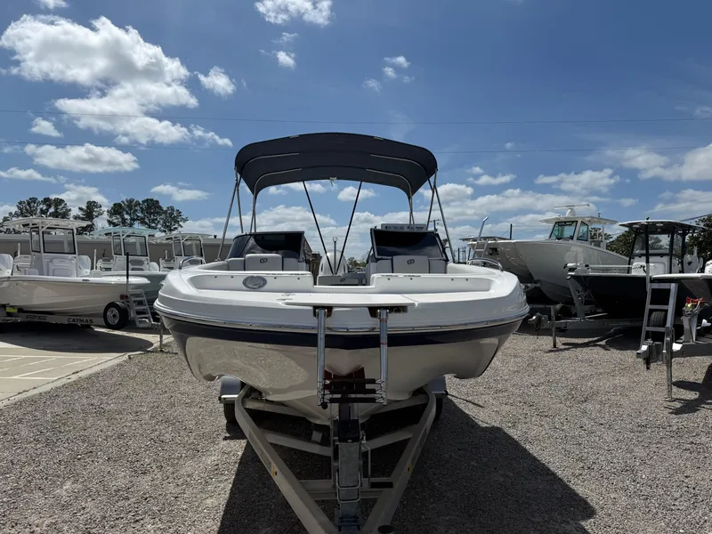Slide: The Image of 2021 Hurricane SunDeck 217 OB boat on trailer under clear blue sky. - 26