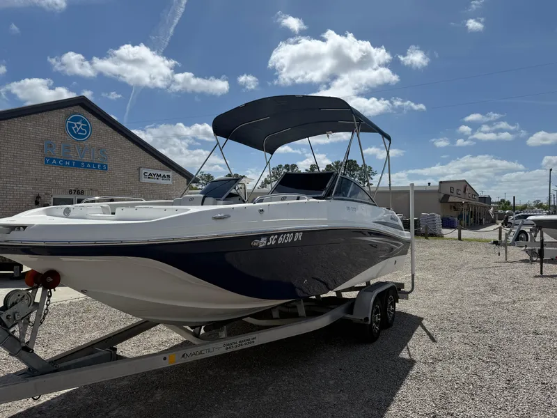 Slide: The Image of 2021 Hurricane SunDeck 217 OB boat on trailer, parked outside yacht sales building. - 27