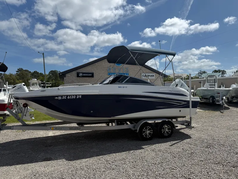 Slide: The Image of 2021 Hurricane SunDeck 217 OB boat on trailer under blue sky. - 28