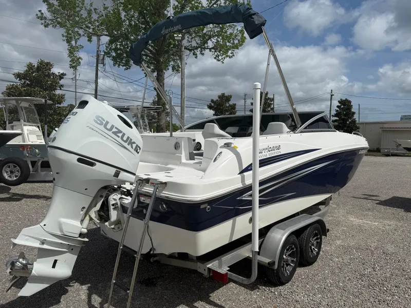 Slide: The Image of 2021 Hurricane SunDeck 217 OB boat with Suzuki outboard motor on a trailer. - 6