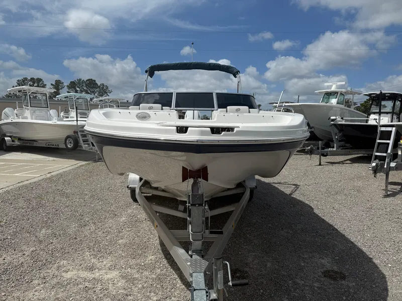 Slide: The Image of 2021 Hurricane SunDeck 217 OB boat on trailer under blue sky. - 9