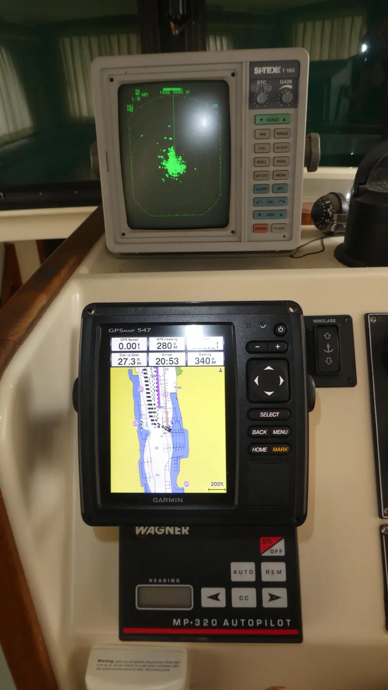 Slide: The Image of Navigation equipment on a 1992 Camano 31 boat, featuring radar and GPS displays. - 11