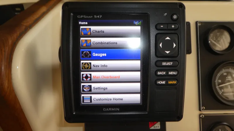 Slide: The Image of Garmin GPS display on 1992 Camano 31 boat, showing navigation options and settings. - 12