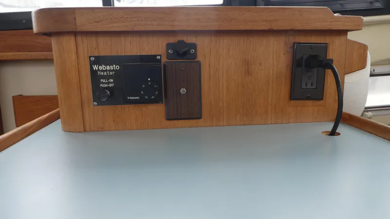 Slide: The Image of Control panel of a 1992 Camano 31 boat featuring a Webasto heater and power outlet. - 17