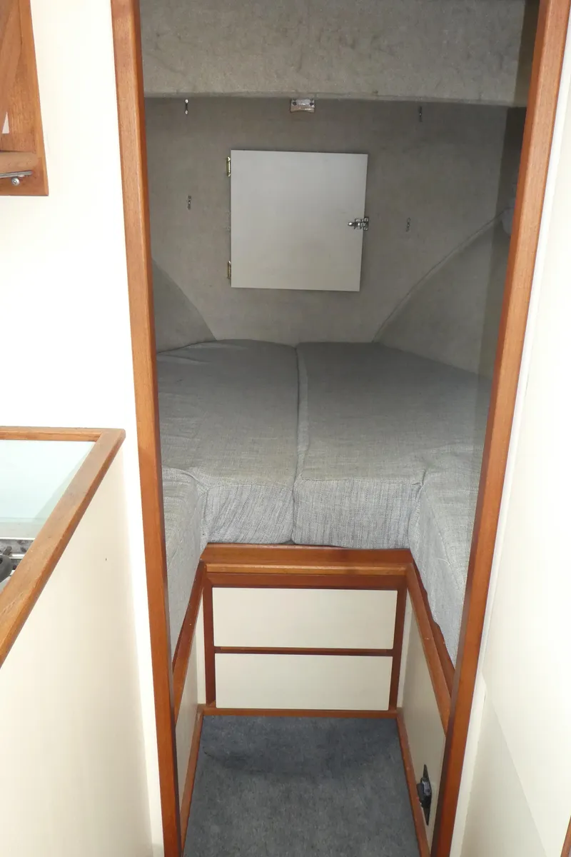 Slide: The Image of 1992 Camano 31 interior cabin with bed and wooden trim. - 19