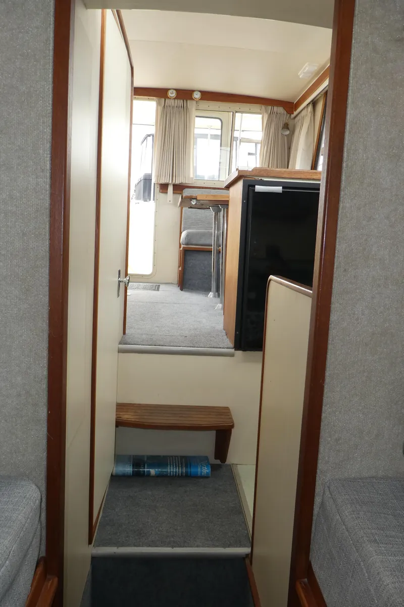 Slide: The Image of Interior view of a 1992 Camano 31 boat, featuring a compact cabin layout. - 21