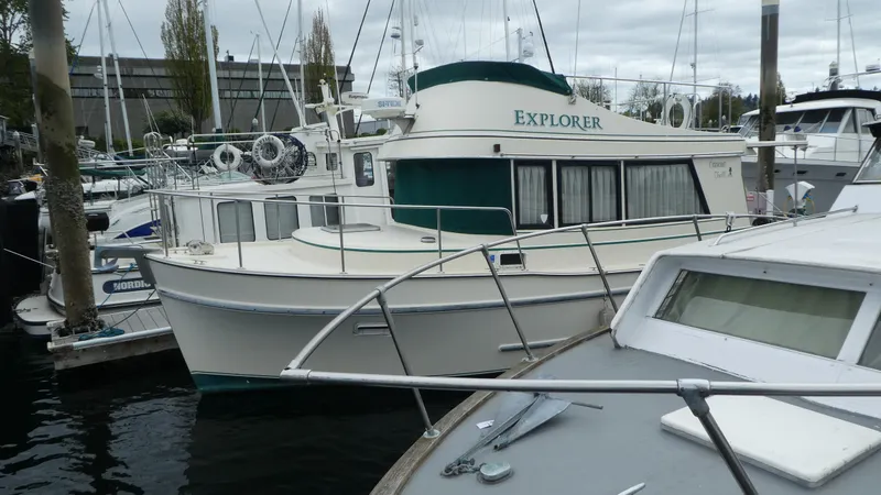 Slide: The Image of 1992 Camano 31 boat named "Explorer" docked at a marina. - 31