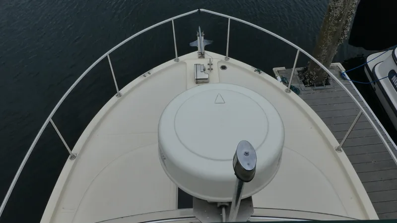 Slide: The Image of Bow view of 1992 Camano 31 boat docked at marina. - 34