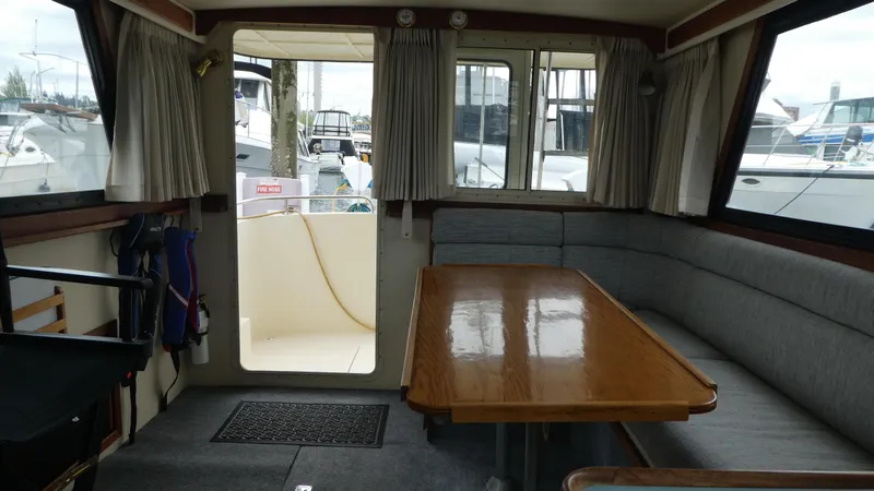 Slide: The Image of Interior of 1992 Camano 31 boat with wooden table and seating area. - 5