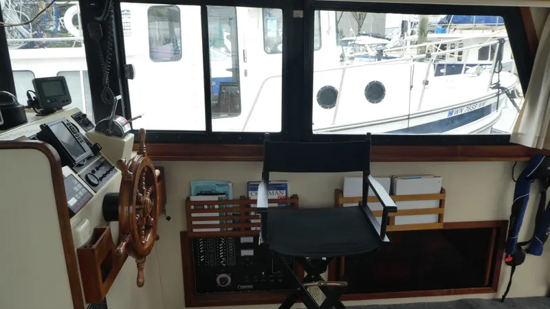 Slide: The Image of Interior of a 1992 Camano 31 boat with steering wheel and navigation equipment. - 8