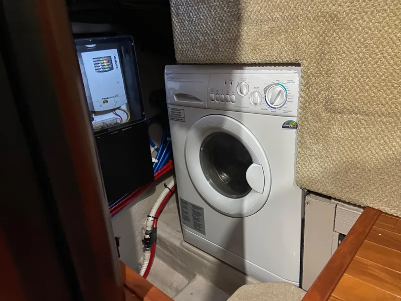 Slide: The Image of Laundry area inside a 2006 Sea Ray 40MY yacht, featuring a washing machine. - 17