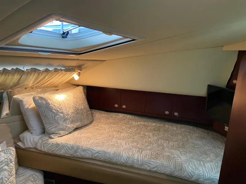Slide: The Image of Luxurious cabin interior of 2006 Sea Ray 40MY yacht with cozy bedding and natural light. - 19