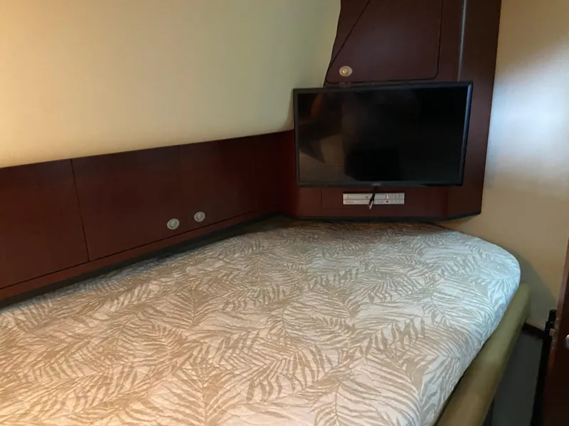 Slide: The Image of Luxurious cabin interior of 2006 Sea Ray 40MY yacht with TV and patterned bedding. - 20