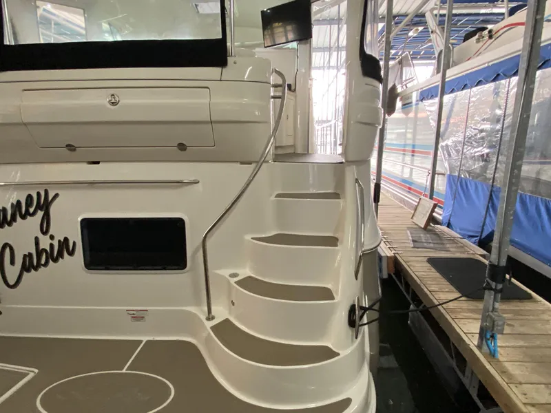 Slide: The Image of 2006 Sea Ray 40MY yacht with elegant staircase and docked in marina. - 3