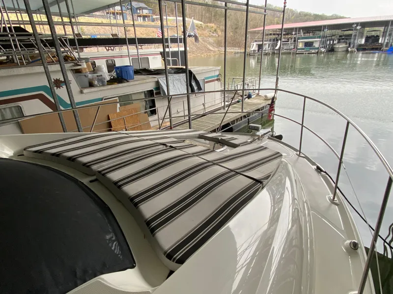 Slide: The Image of 2006 Sea Ray 40MY yacht docked in marina, featuring striped sunpad and sleek design. - 31