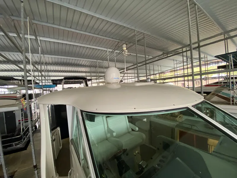 Slide: The Image of 2006 Sea Ray 40MY yacht under covered dock, showcasing helm and radar equipment. - 36