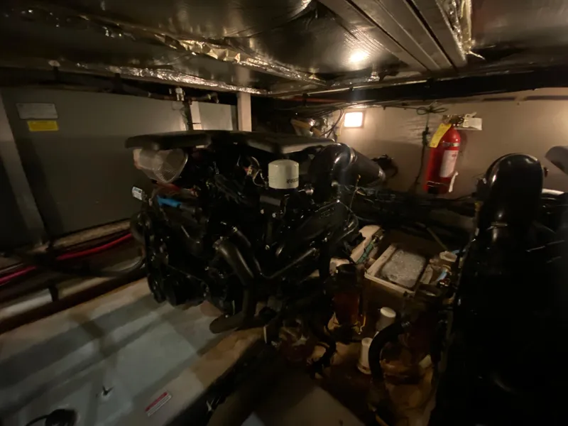 Slide: The Image of Engine room of a 2006 Sea Ray 40MY yacht, featuring mechanical components and fire extinguisher. - 38