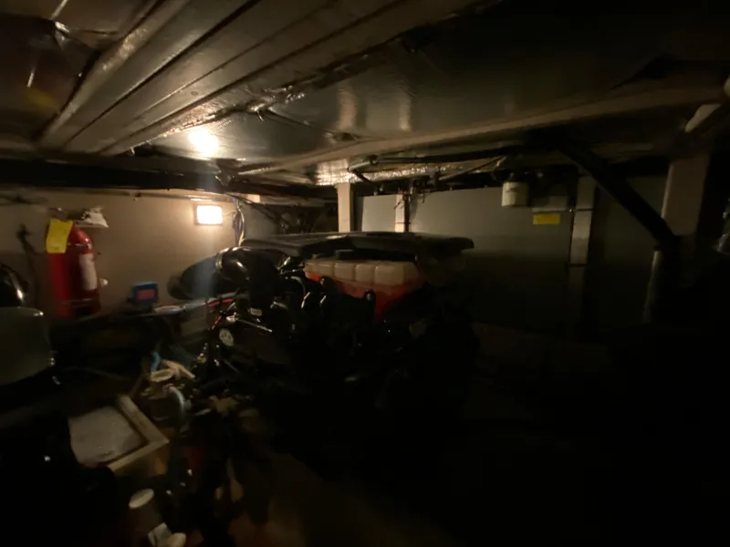Slide: The Image of Dimly lit engine room of 2006 Sea Ray 40MY yacht, featuring machinery and equipment. - 39