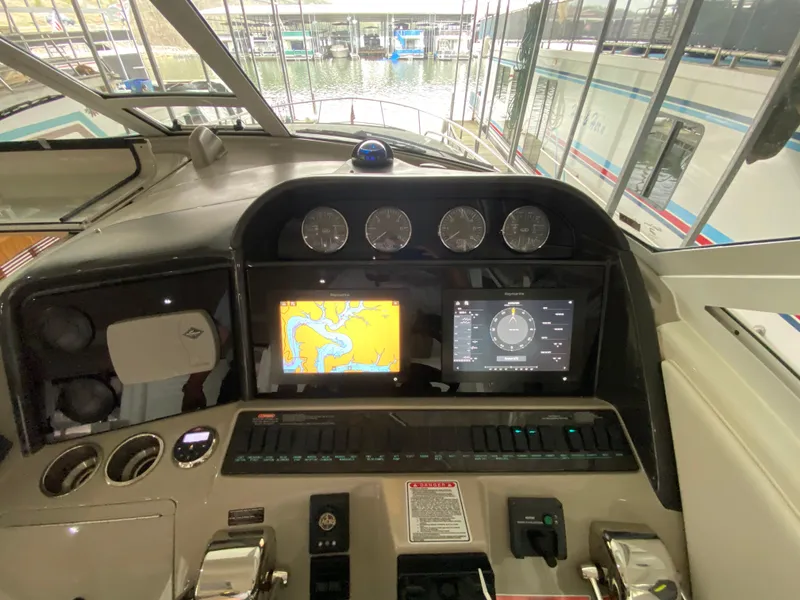 Slide: The Image of Cockpit of 2006 Sea Ray 40MY yacht with navigation screens and controls. - 8