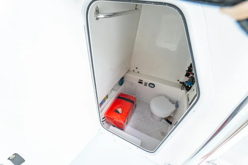 Slide: The Image of Interior of 2018 Albury Brothers 33 boat showing compact marine toilet and storage. - 30