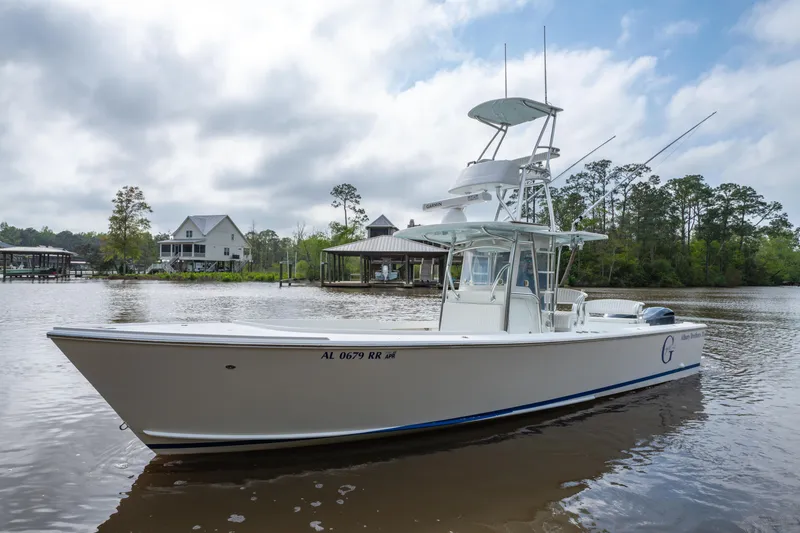 Slide: The Image of 2018 Albury Brothers 33 boat on a calm river with houses in the background. - 7