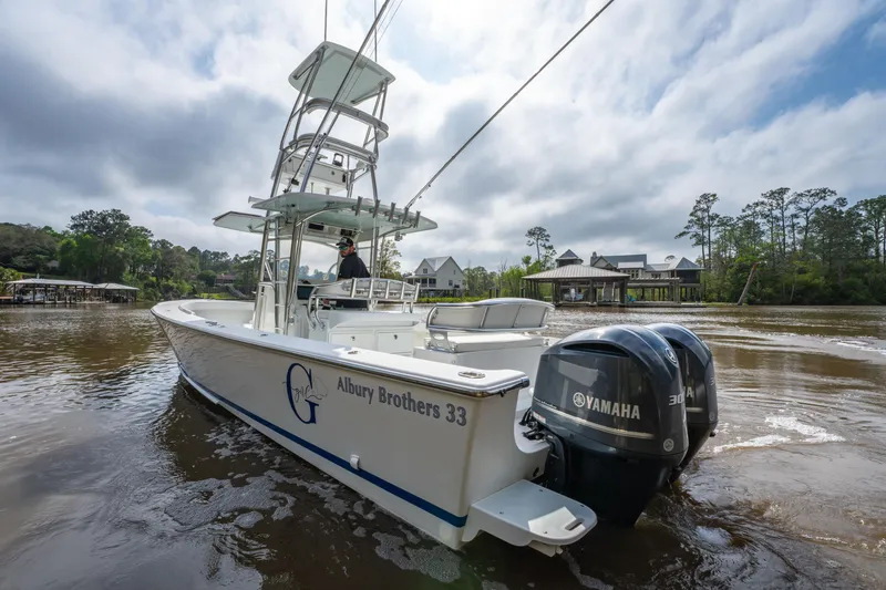 Slide: The Image of 2018 Albury Brothers 33 boat with dual Yamaha engines on a scenic river. - 9