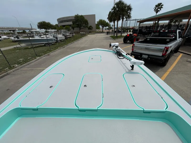 Slide: The Image of 2022 Shallow Sport 25 X3 boat docked, featuring a sleek deck design and modern equipment. - 11