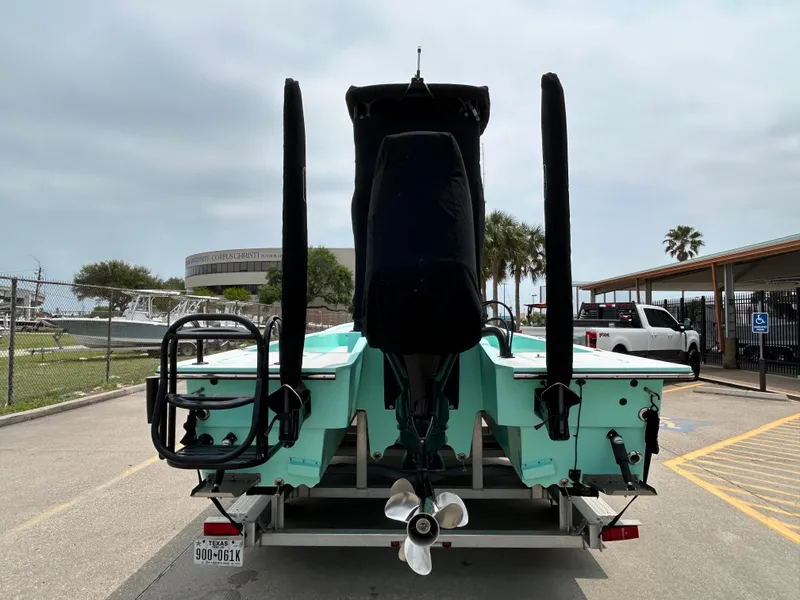 Slide: The Image of 2022 Shallow Sport 25 X3 boat on trailer, rear view, parked in marina lot. - 19