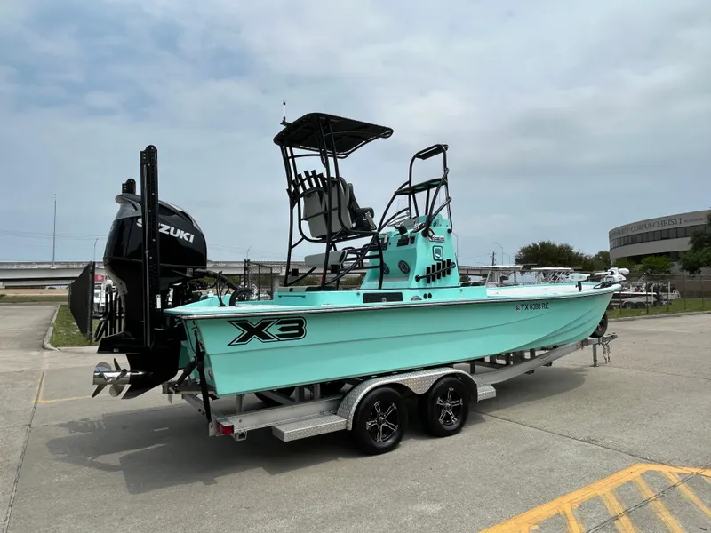 Slide: The Image of 2022 Shallow Sport 25 X3 boat on trailer, featuring Suzuki outboard motor. - 5