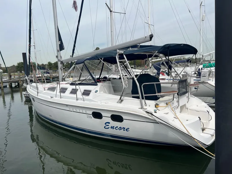 The Image of 2002 Hunter 386 sailboat named "Encore" docked in a marina. - 0