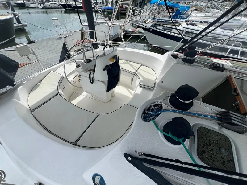 Slide: The Image of Cockpit of a 2002 Hunter 386 sailboat docked at a marina. - 11