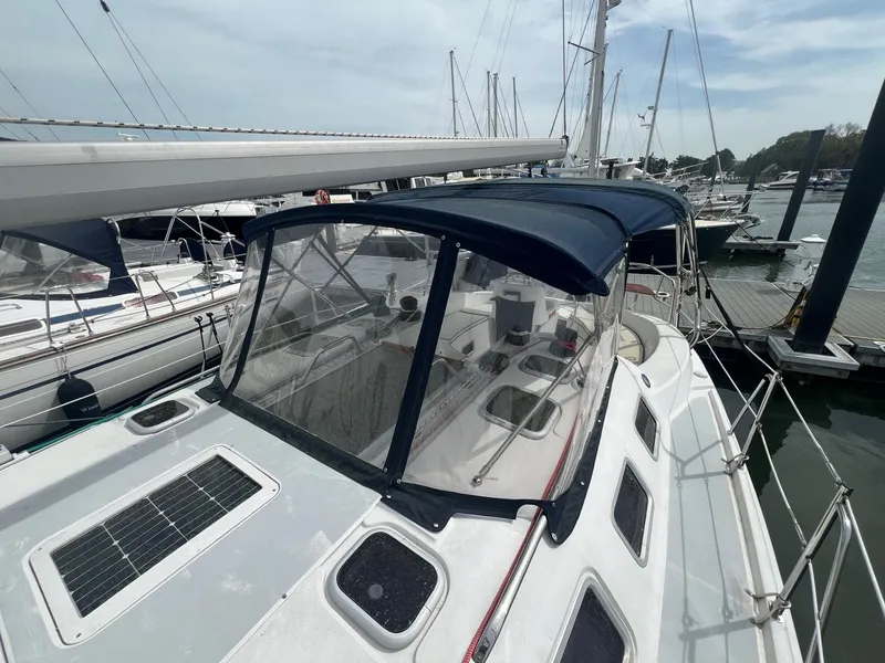 Slide: The Image of 2002 Hunter 386 sailboat docked at marina with blue canopy and solar panel. - 13