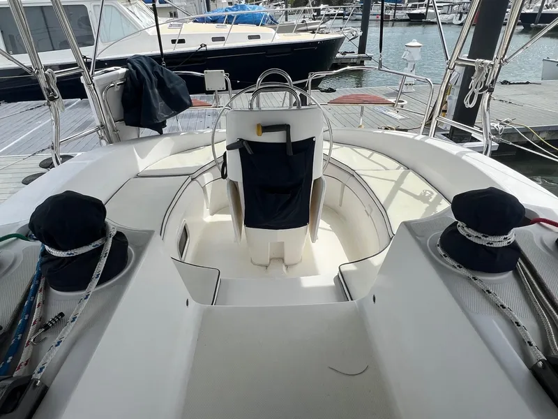 Slide: The Image of 2002 Hunter 386 sailboat cockpit with steering wheel, docked at marina. - 14