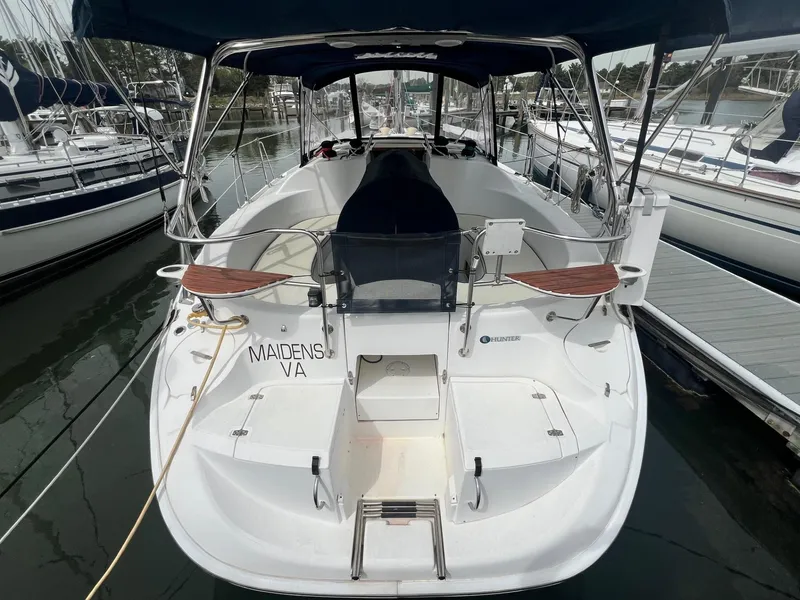 Slide: The Image of Hunter 386 sailboat, 2002 model, docked at marina with visible cockpit and seating area. - 2