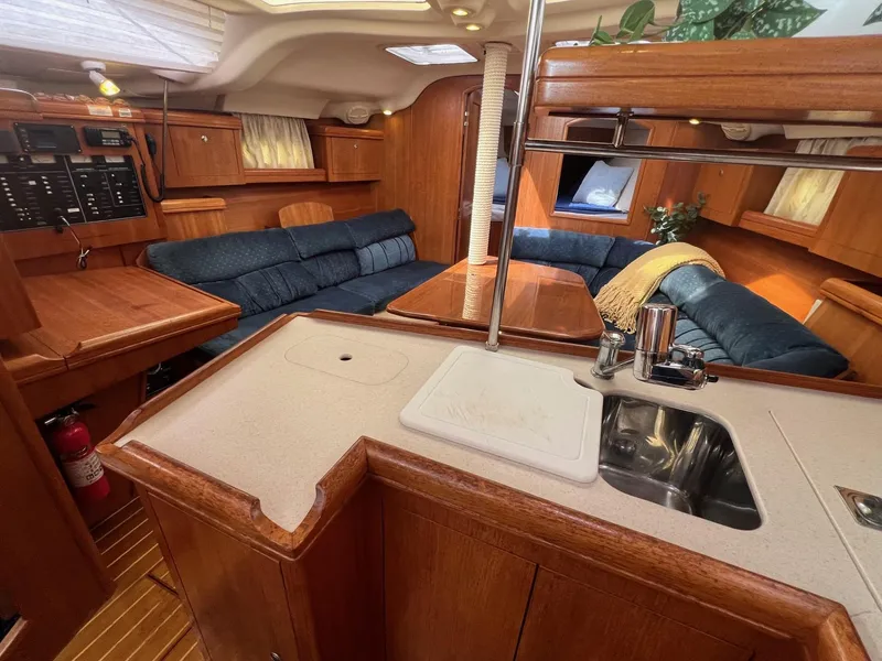 Slide: The Image of Interior of 2002 Hunter 386 sailboat with cozy seating and compact kitchen area. - 20