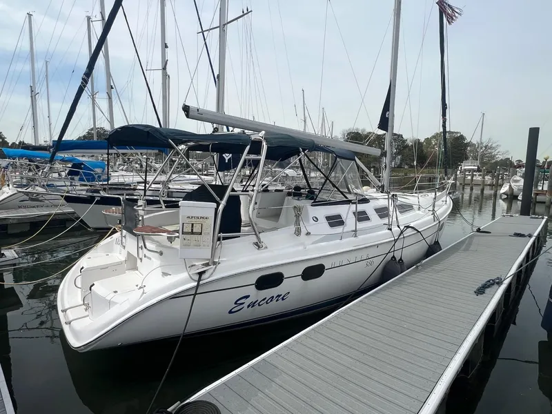 Slide: The Image of Hunter 386 sailboat, 2002 model, docked at marina with blue canopy and "Encore" name. - 3