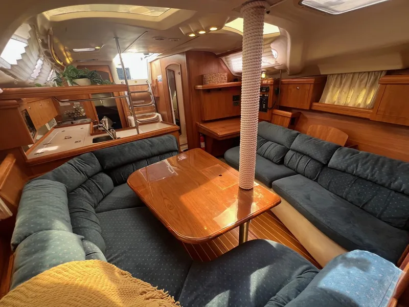 Slide: The Image of Spacious interior of 2002 Hunter 386 sailboat with cozy seating and wooden table. - 34