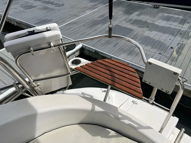 Slide: The Image of Hunter 386 sailboat cockpit with wooden seat and dock view, 2002 model. - 5