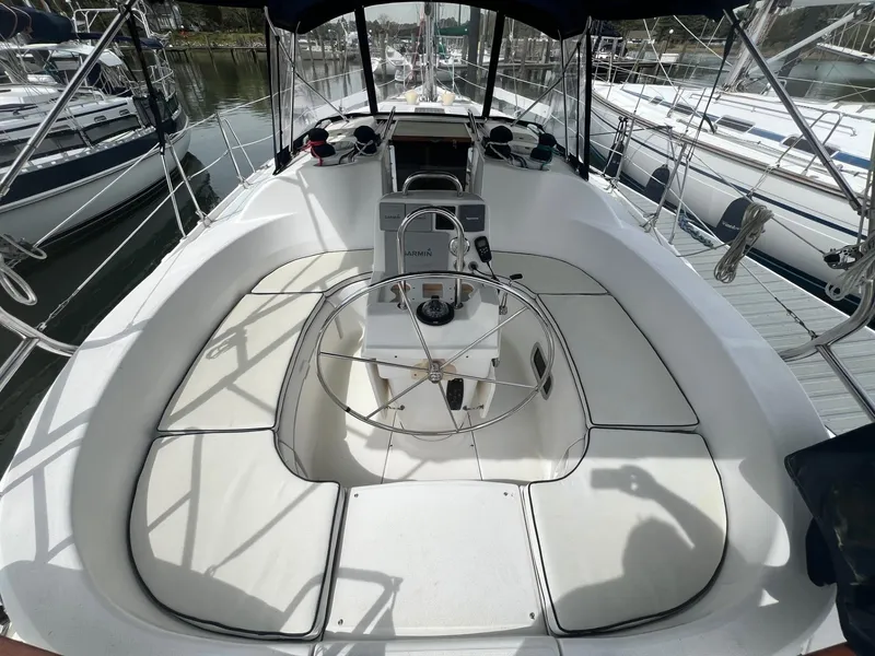 Slide: The Image of Cockpit of a 2002 Hunter 386 sailboat with steering wheel and seating. - 7