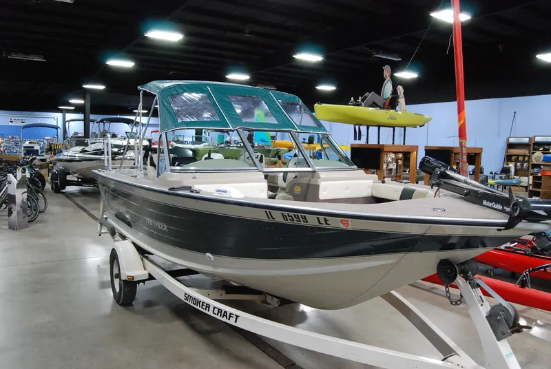 Slide: The Image of 1998 Smoker Craft 178 Fazer boat on trailer in showroom. - 0