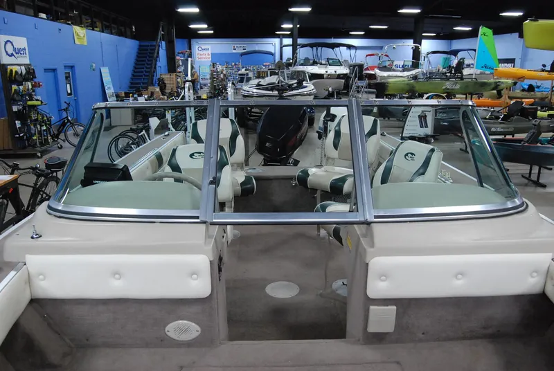 Slide: The Image of 1998 Smoker Craft 178 Fazer boat interior in showroom, featuring seating and windshield. - 20
